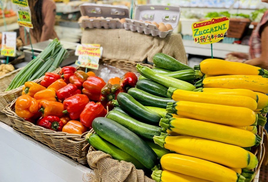 zucchini and tomatoes on display at farmers market