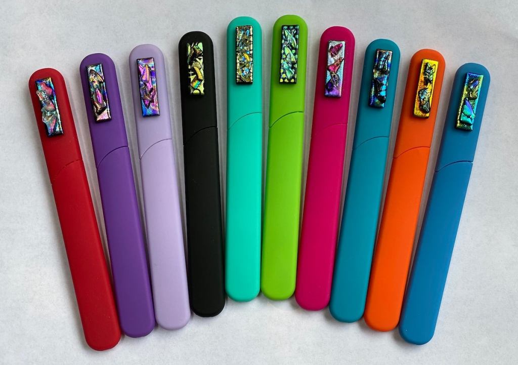 row of colorful sticks on white surface