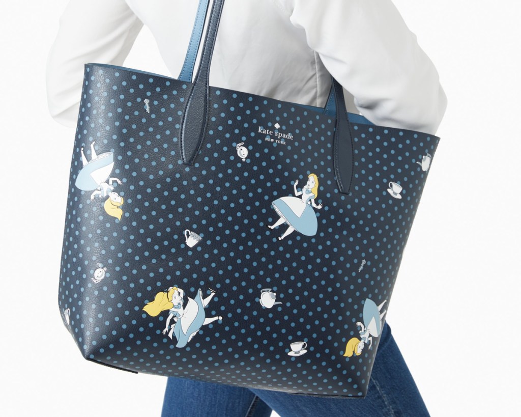 kate spade alice in wonderland tote on womans arm