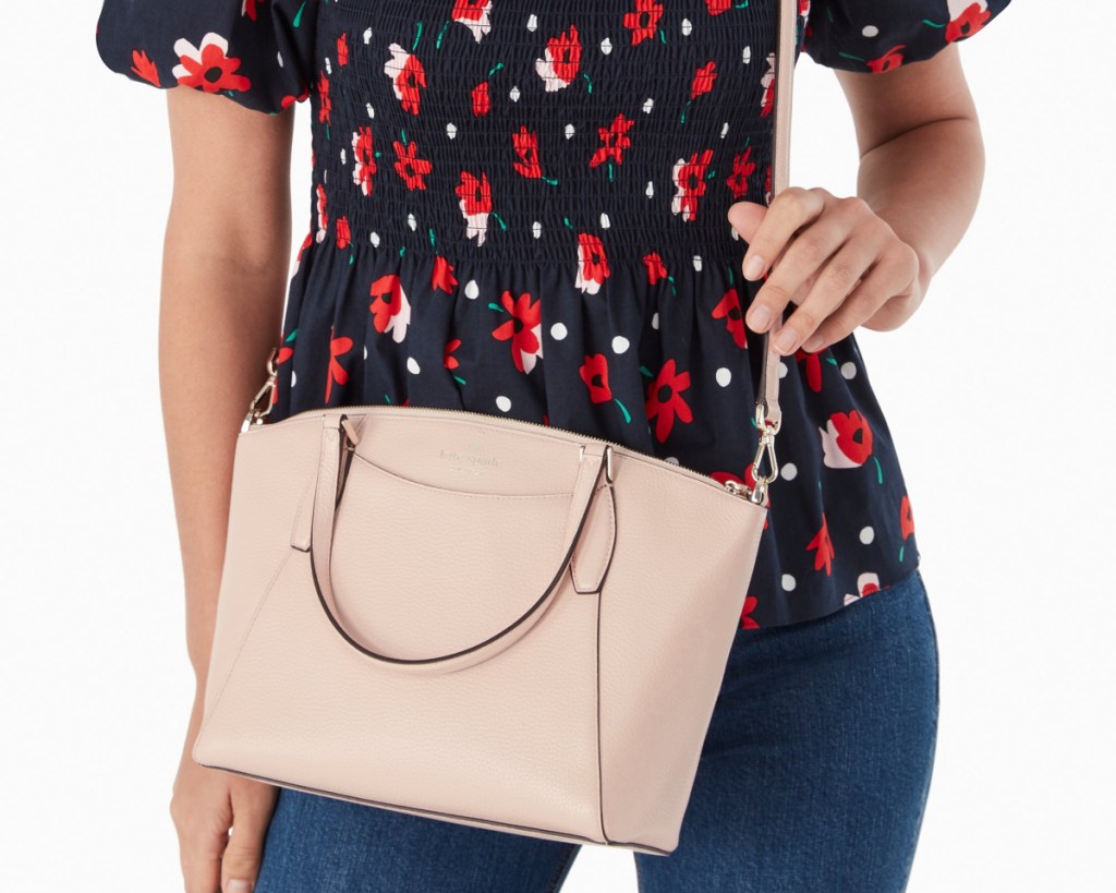 kate spade blush bag on womans arm