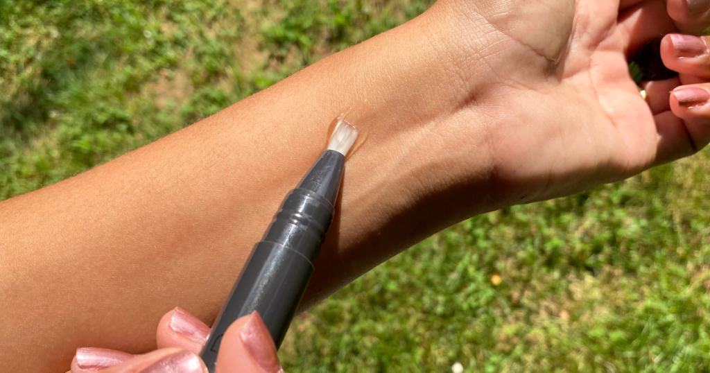 woman putting fragrance on her wrist