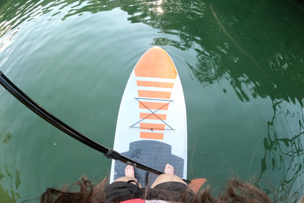 Woman standing on SUP with paddle