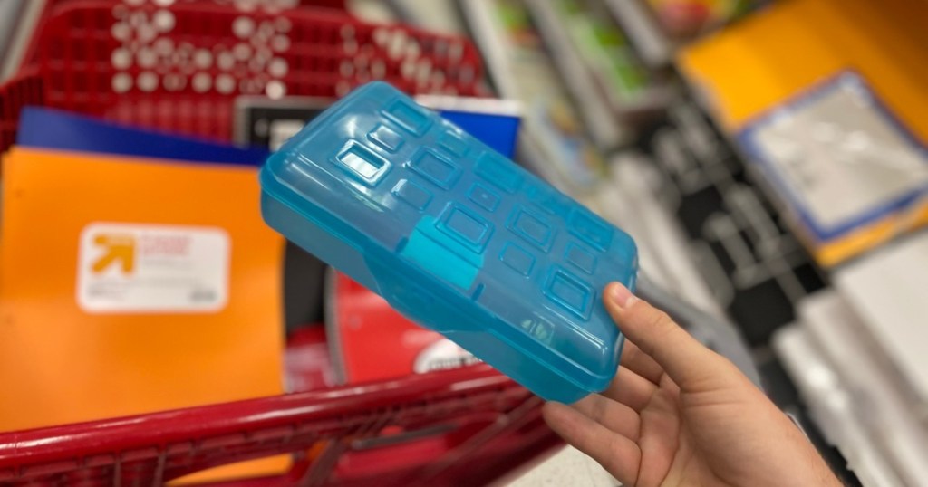 holding a blue pencil box