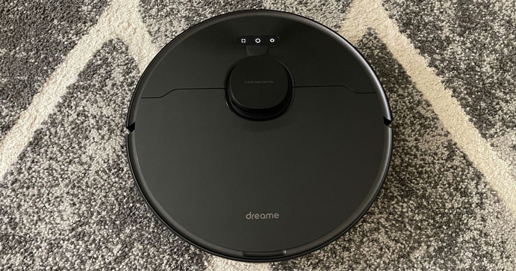 black robotic vacuum on rug