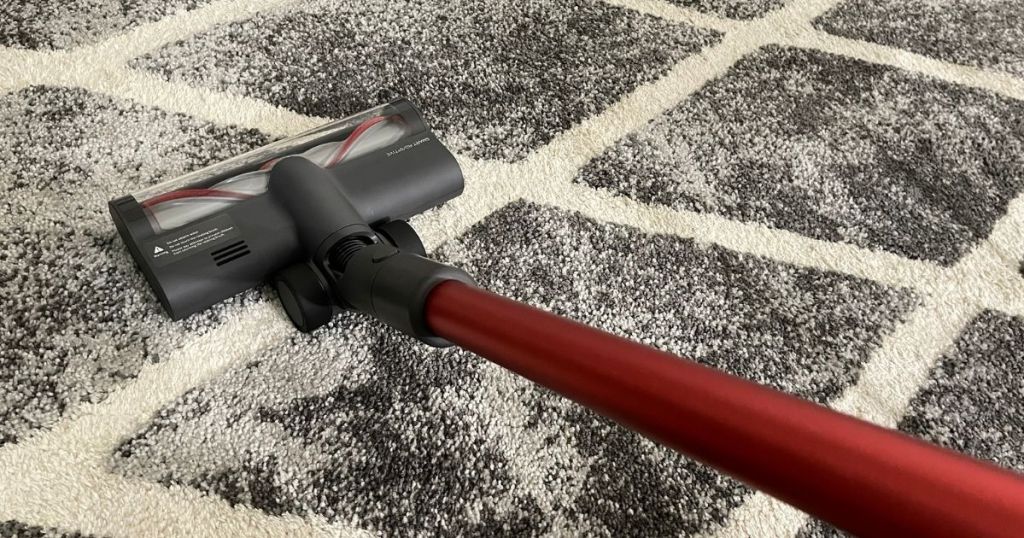 red stick vacuum cleaning rug