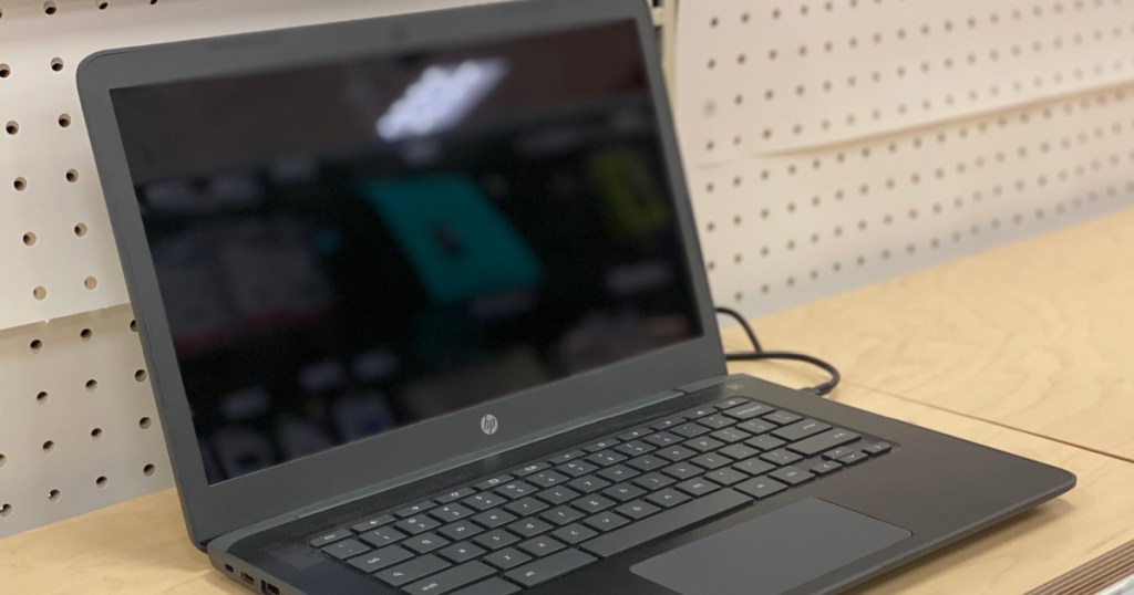 black laptop on shelf 