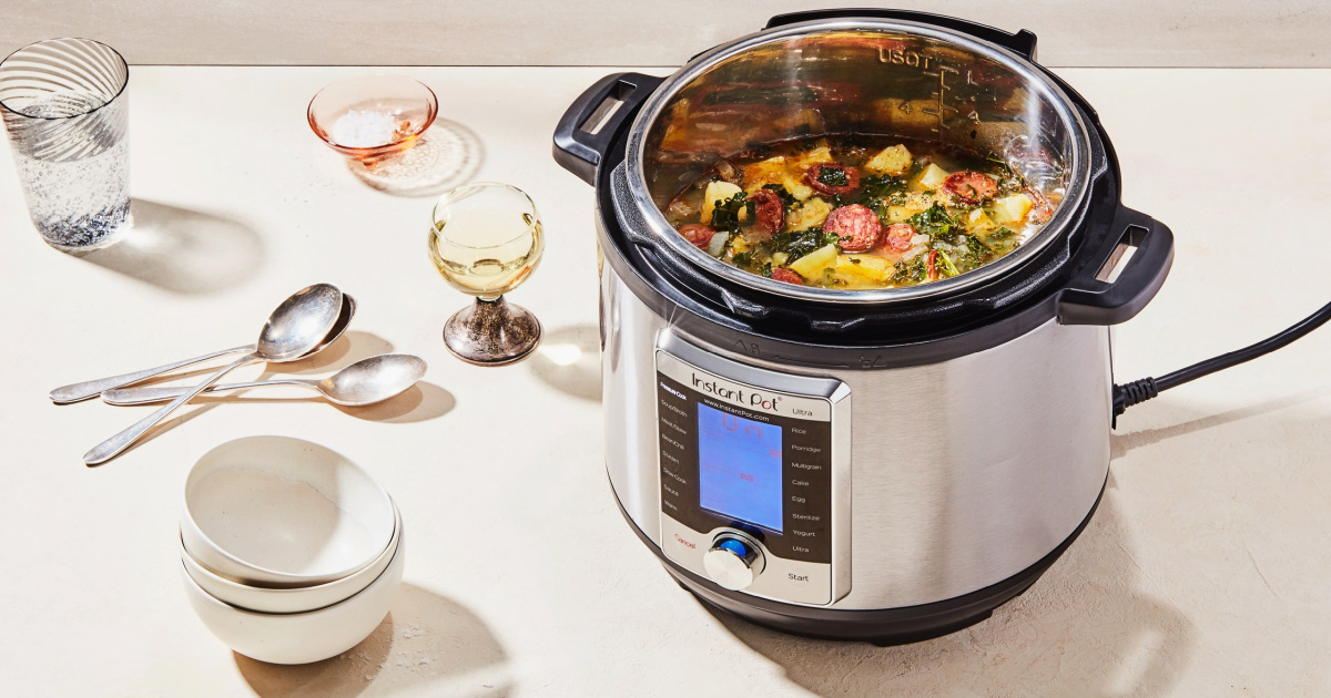 instant pot with soup inside and dishes on table