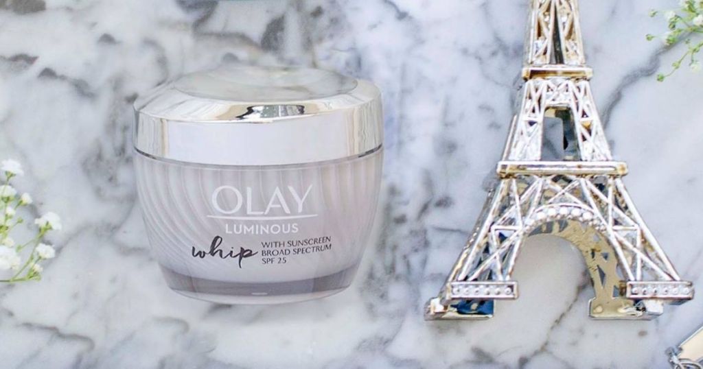 Olay moisturizer next to a mini eiffel tower