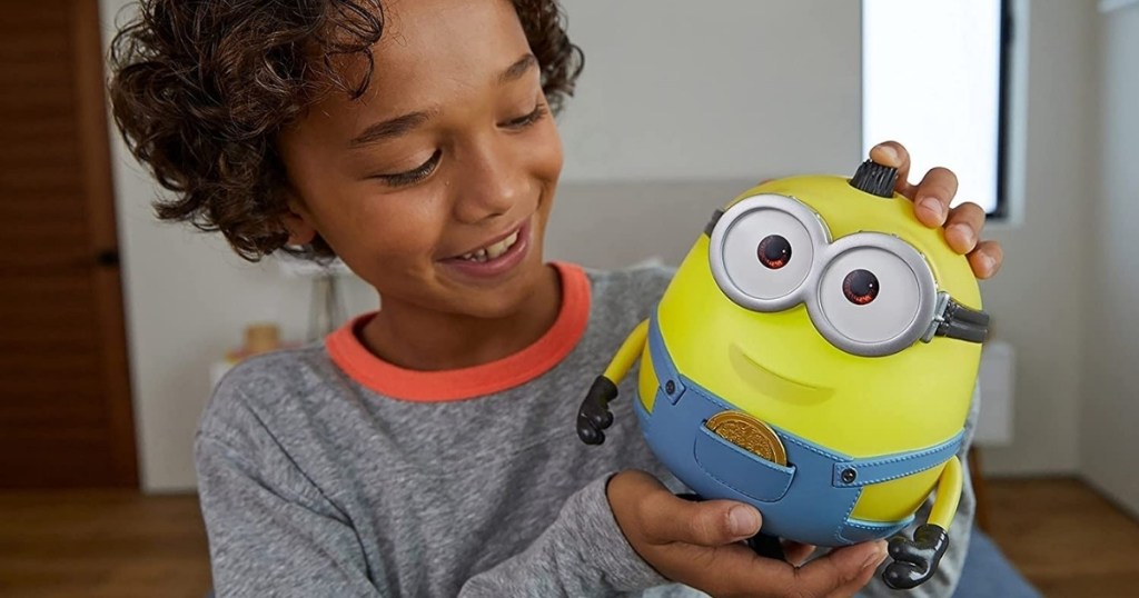 child holding minion otto babble interactive toy