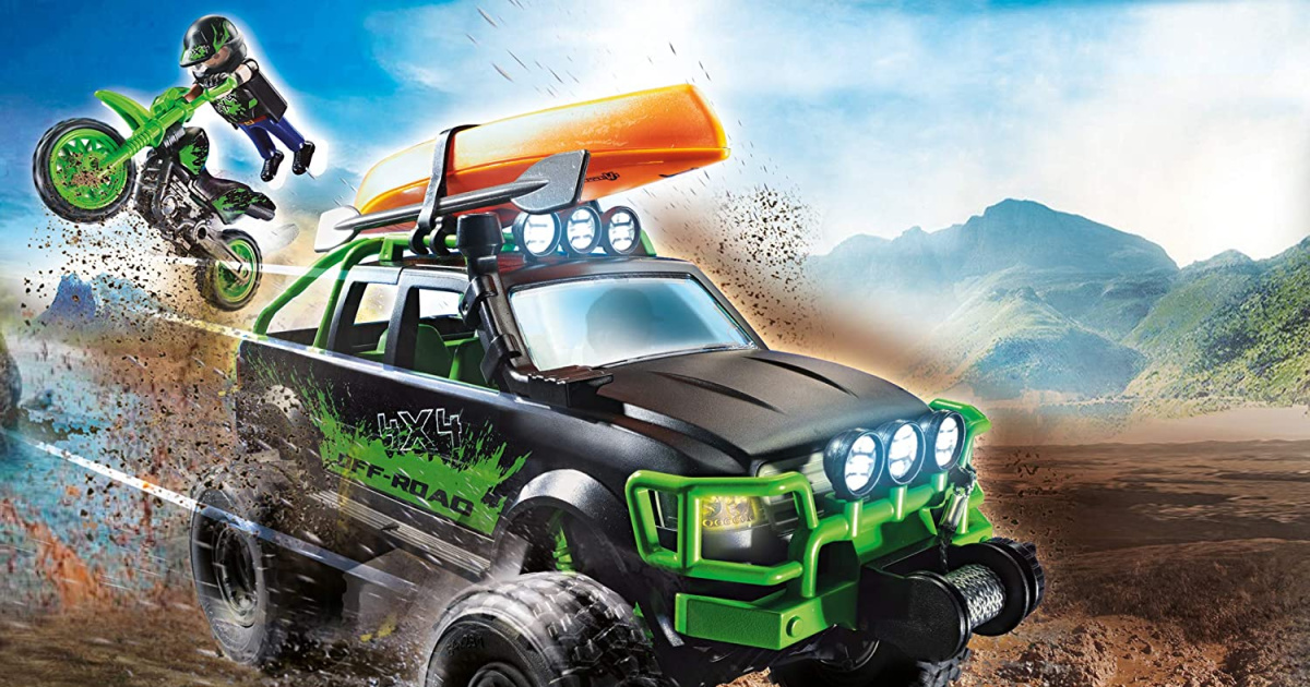 stock image of an off road playmobil truck with figure jumping off the back with motorcycle
