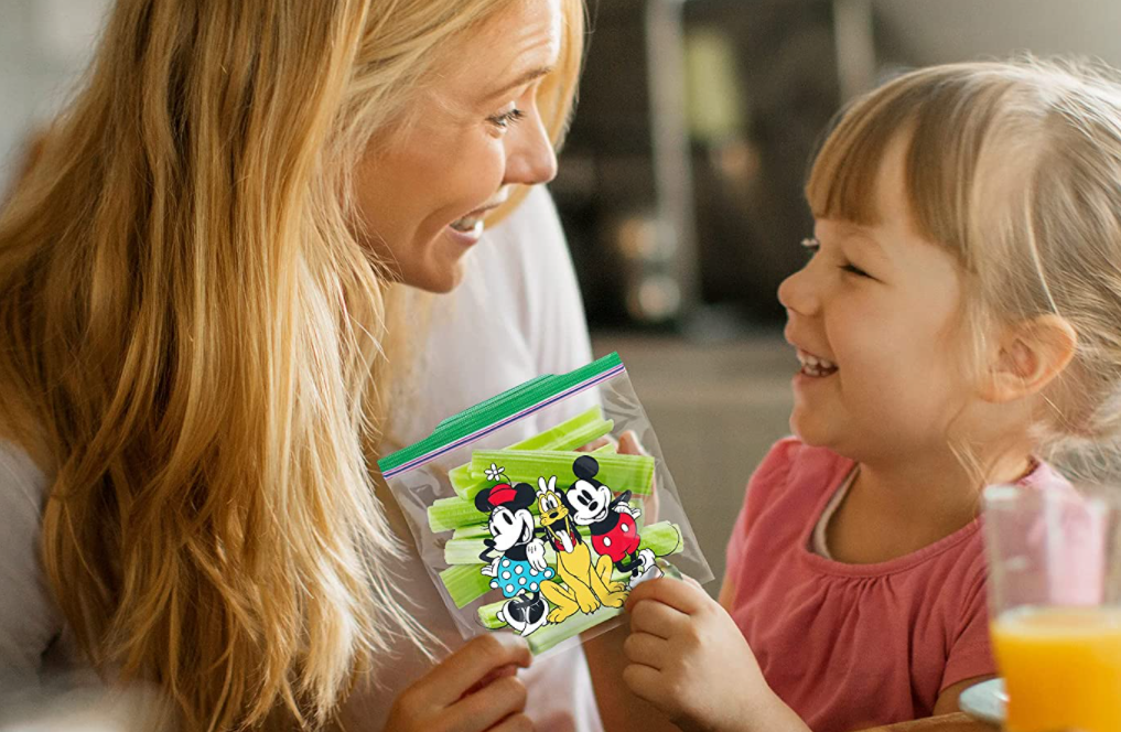 woman and girl holding a Disney Ziploc bag