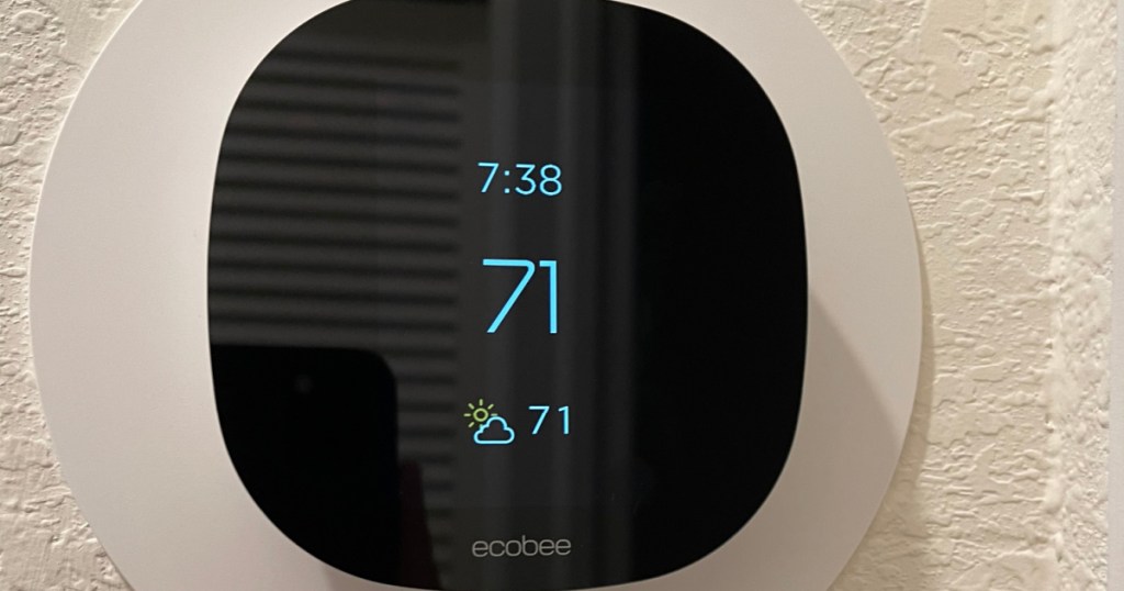 black thermostat displaying temperature on the wall