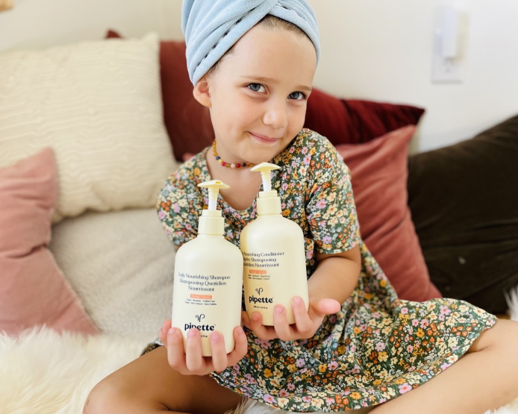 girl holding pipette bottles