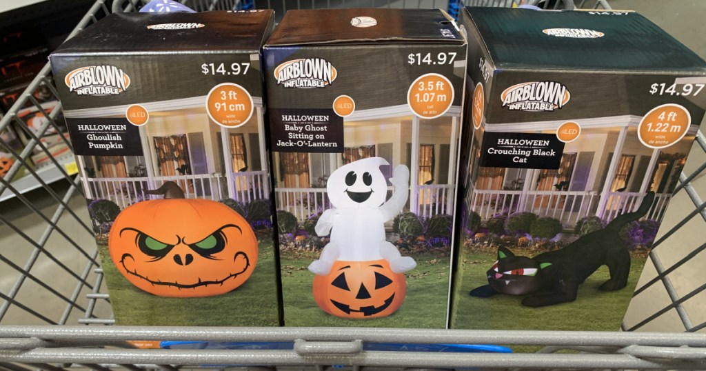 store cart with 3 boxes containing halloween inflatables in them