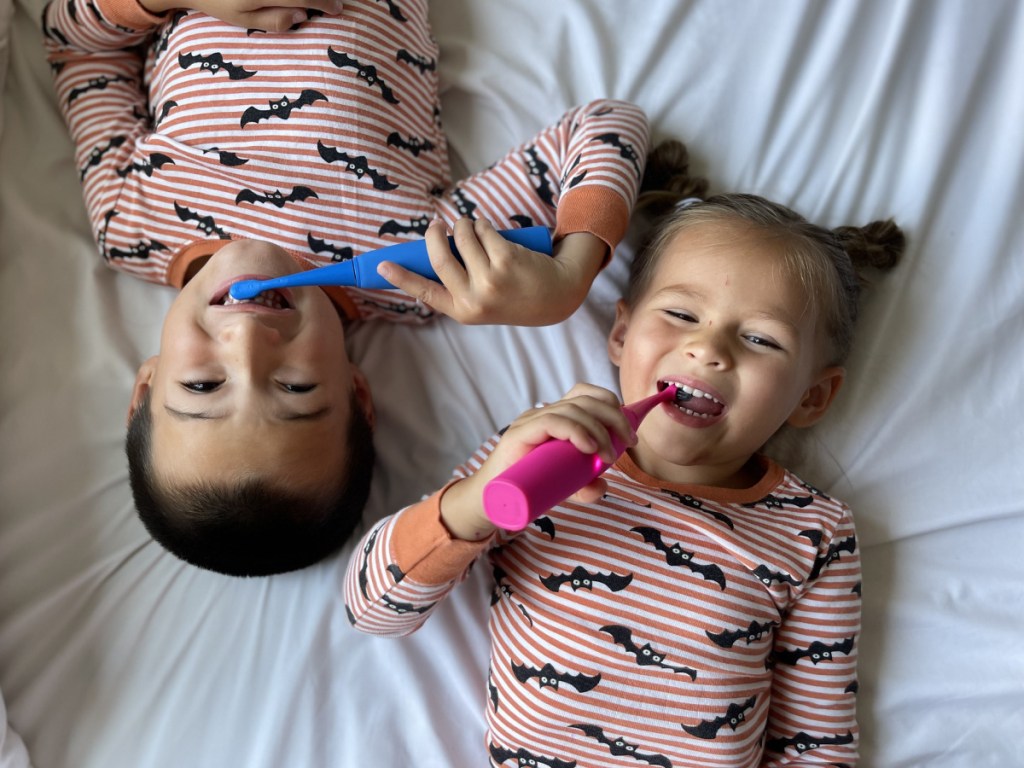 kids using burst toothbrushes laying down