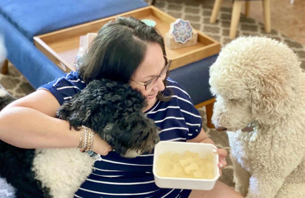 woman with two dogs and homemade treats 