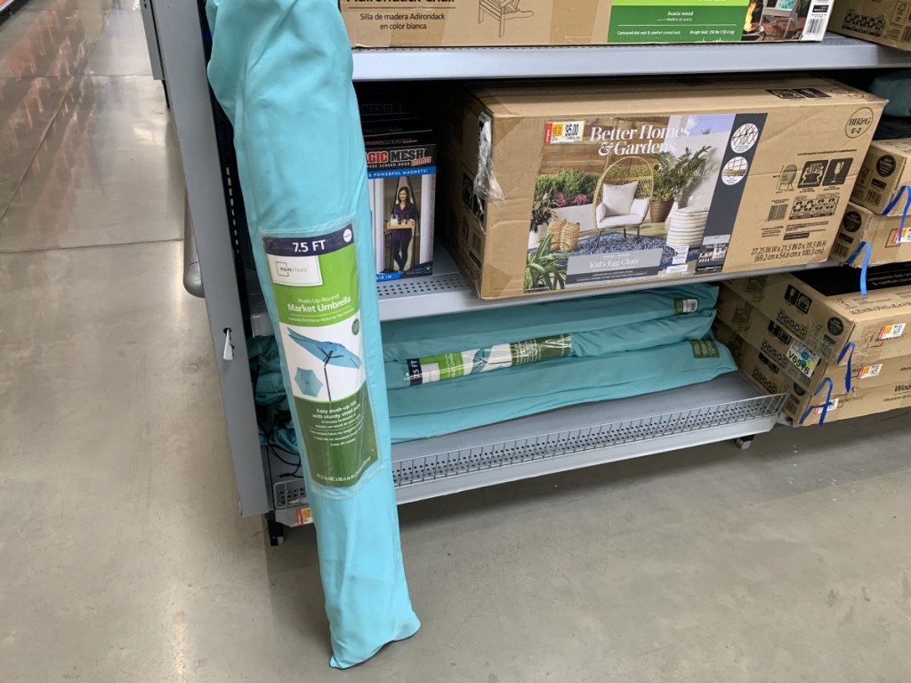 folded up umbrella in case by store aisle