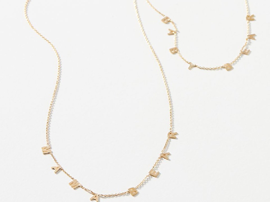 2 gold necklaces on white background