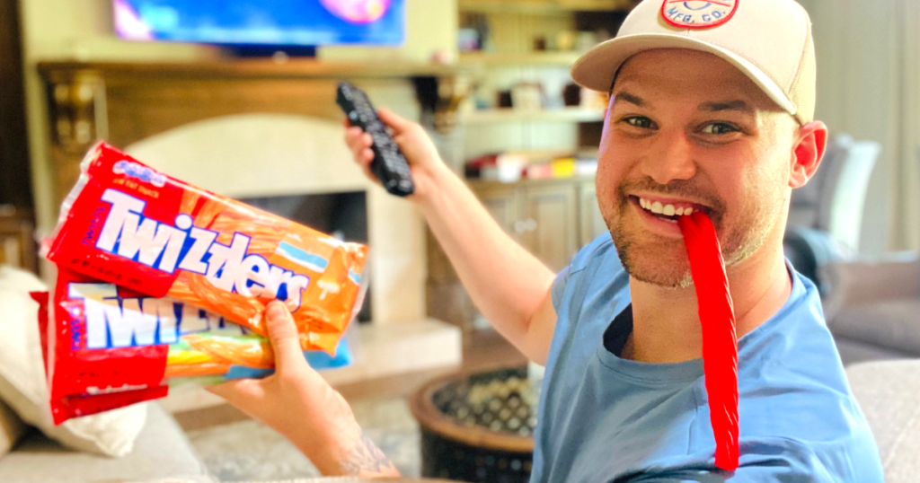 man eating Twizzlers and watching movies 