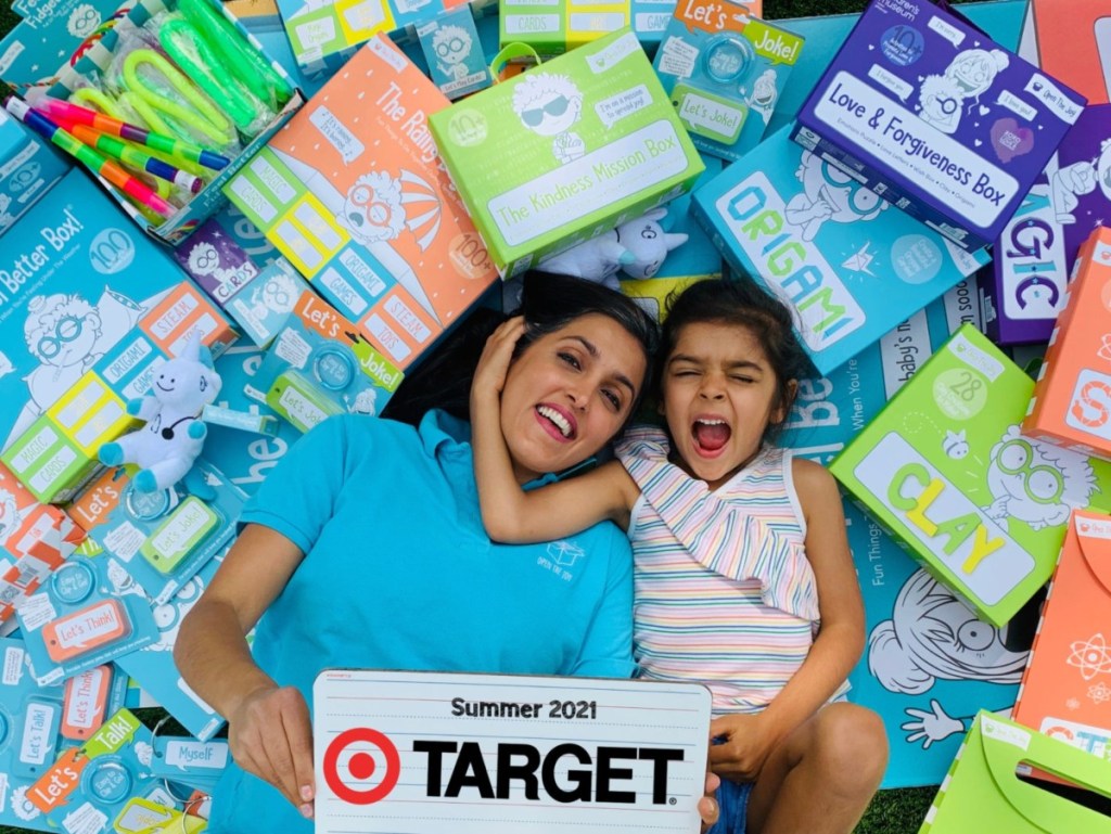 woman and child on pile of Open the Joy products