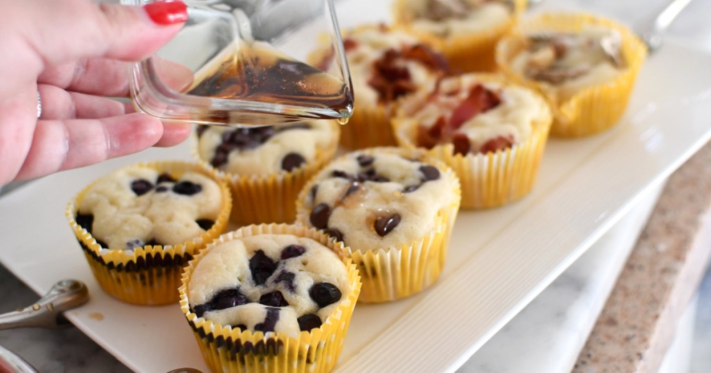 pouring syrup over pancake muffins 