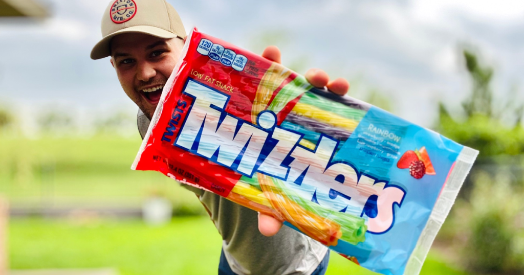 man holding rainbow twizzlers 