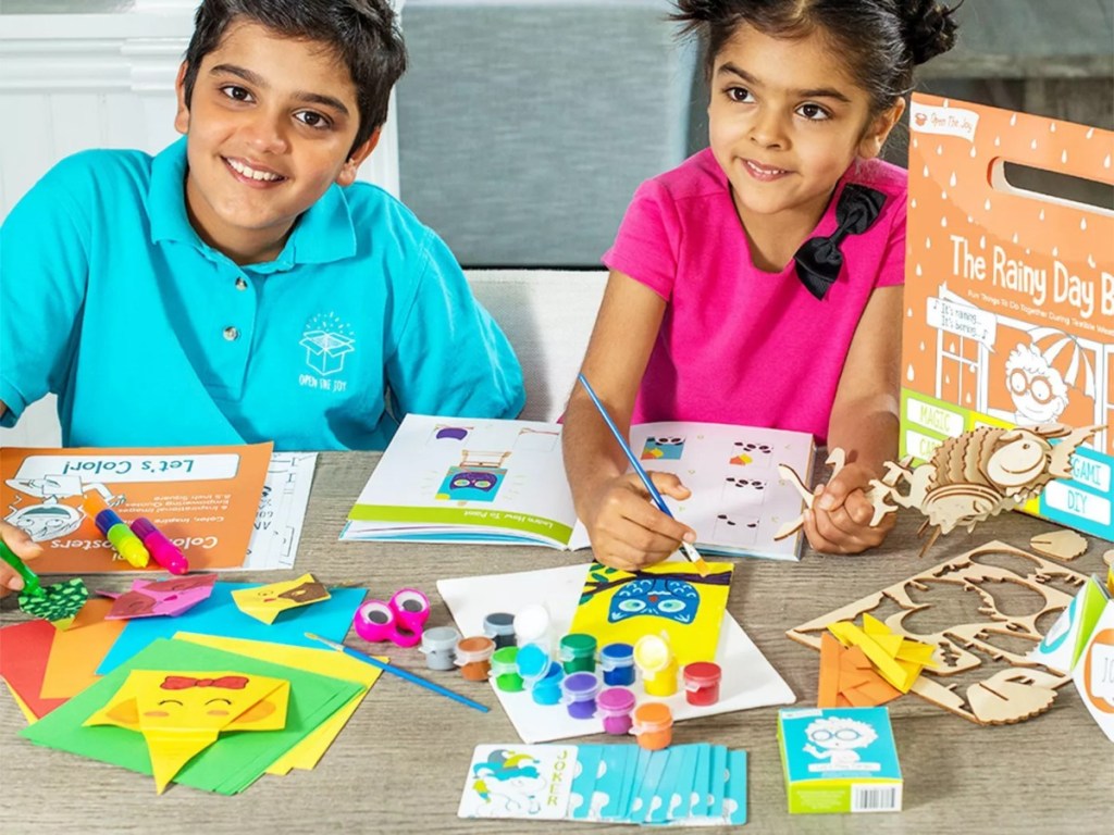 kids playing with contents of rainy day box