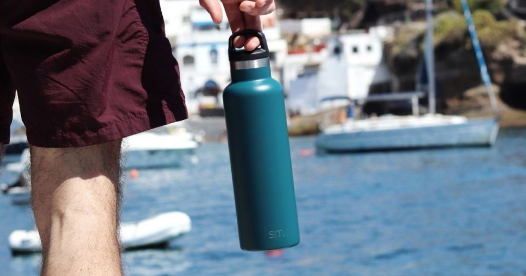 man carrying green water bottle