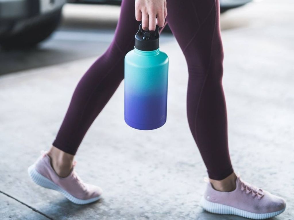 woman carrying water bottle