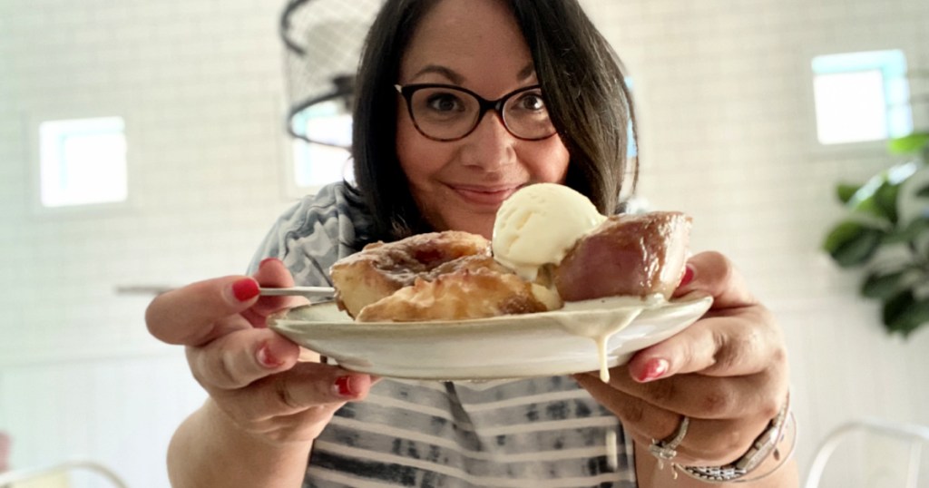 woman holding easy peach cobbler