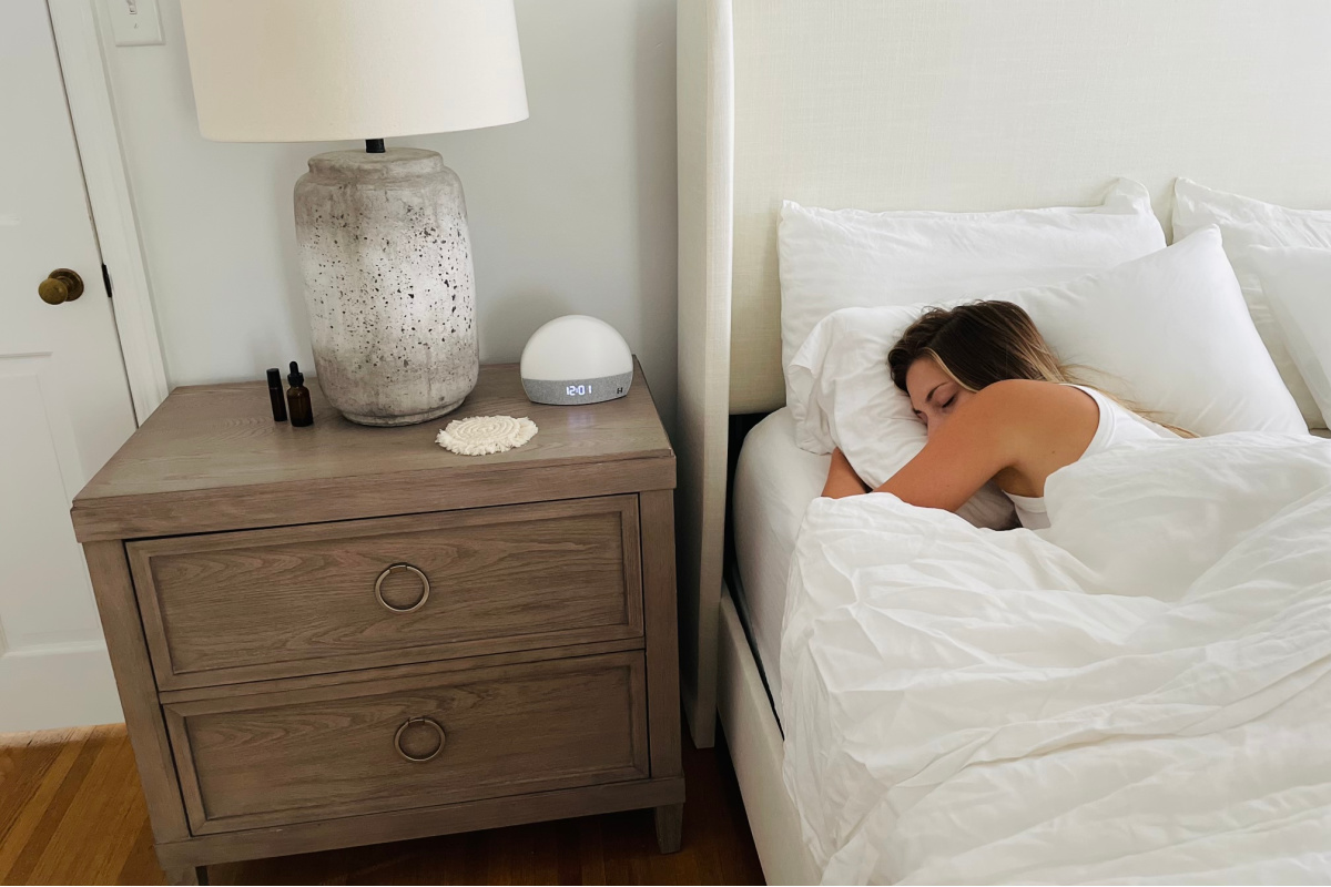 woman sleeping beside hatch sound machine - sound machine for sleep