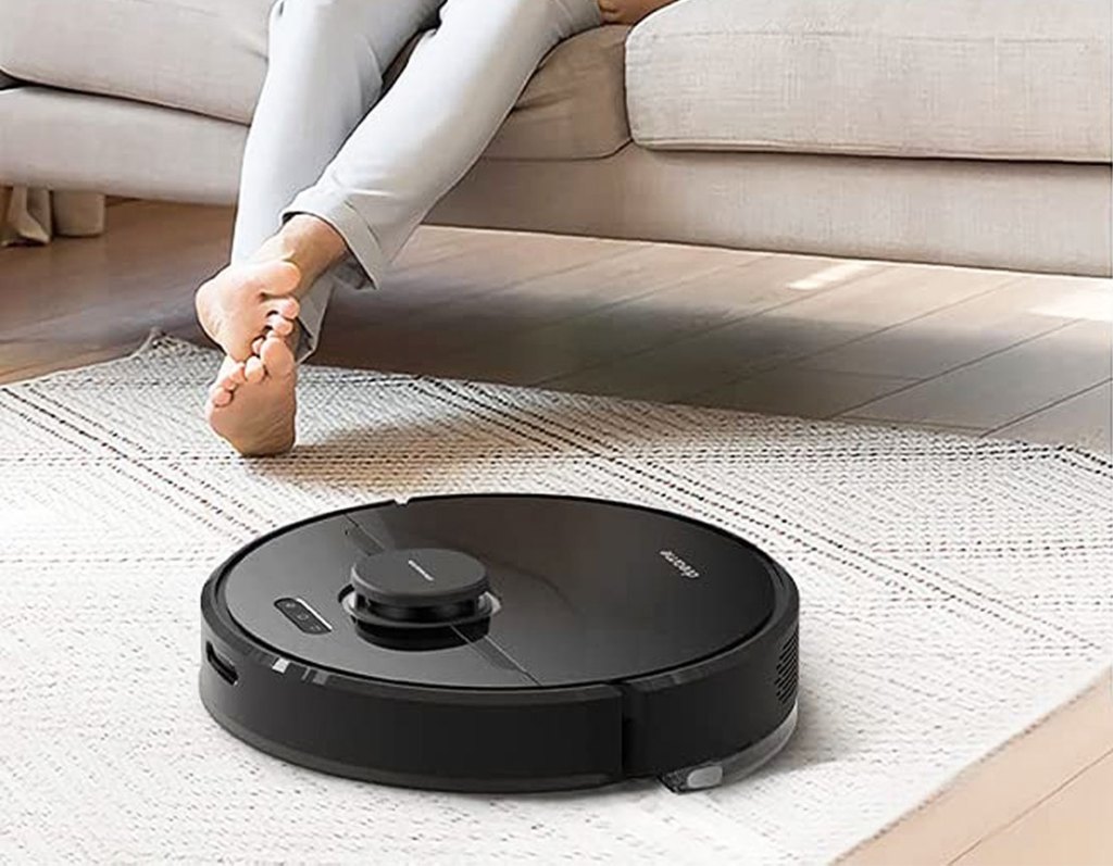 black robot vacuum on area rug