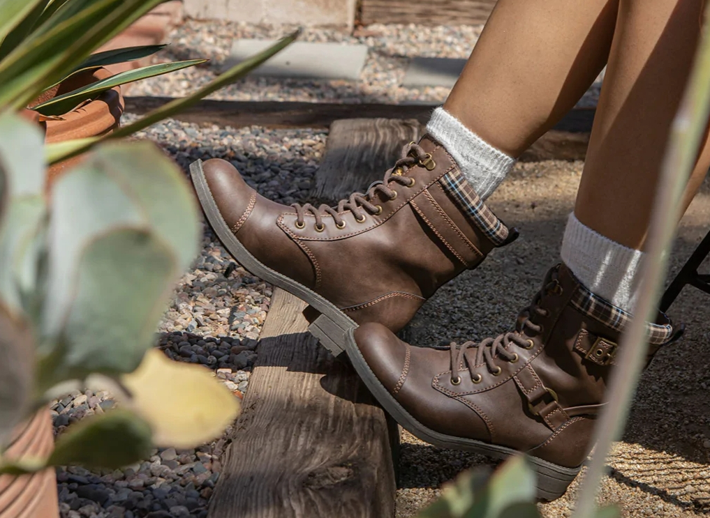 person wearing a pair of brown boots and tall socks