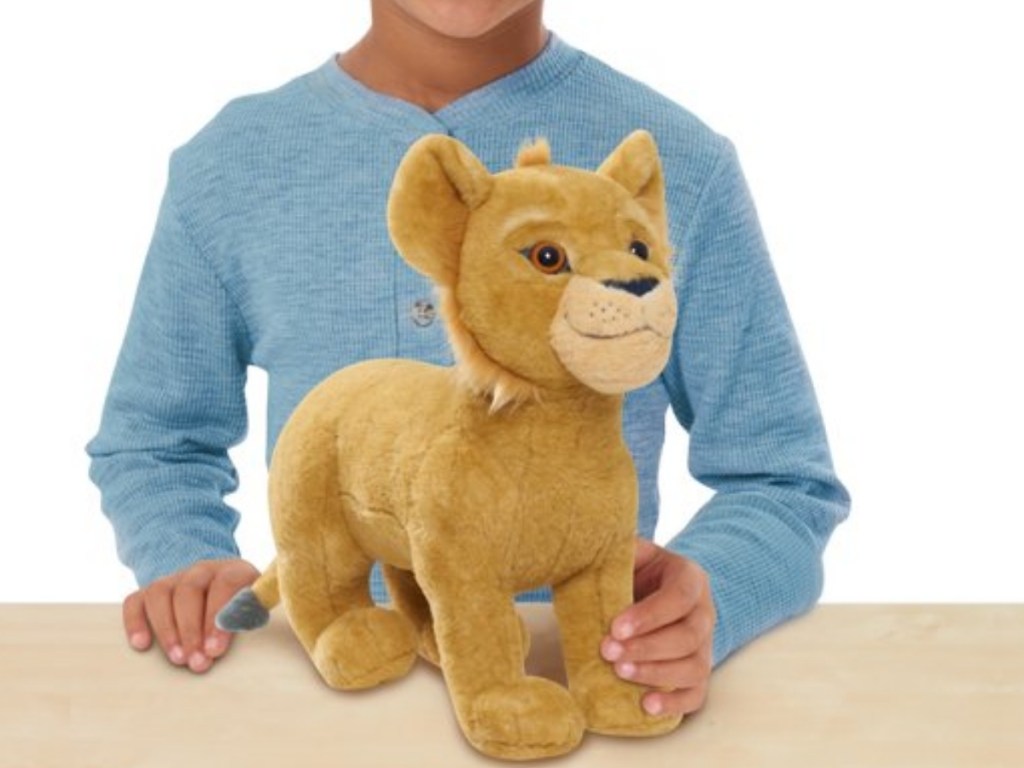 boy with simba plush toy the lion king