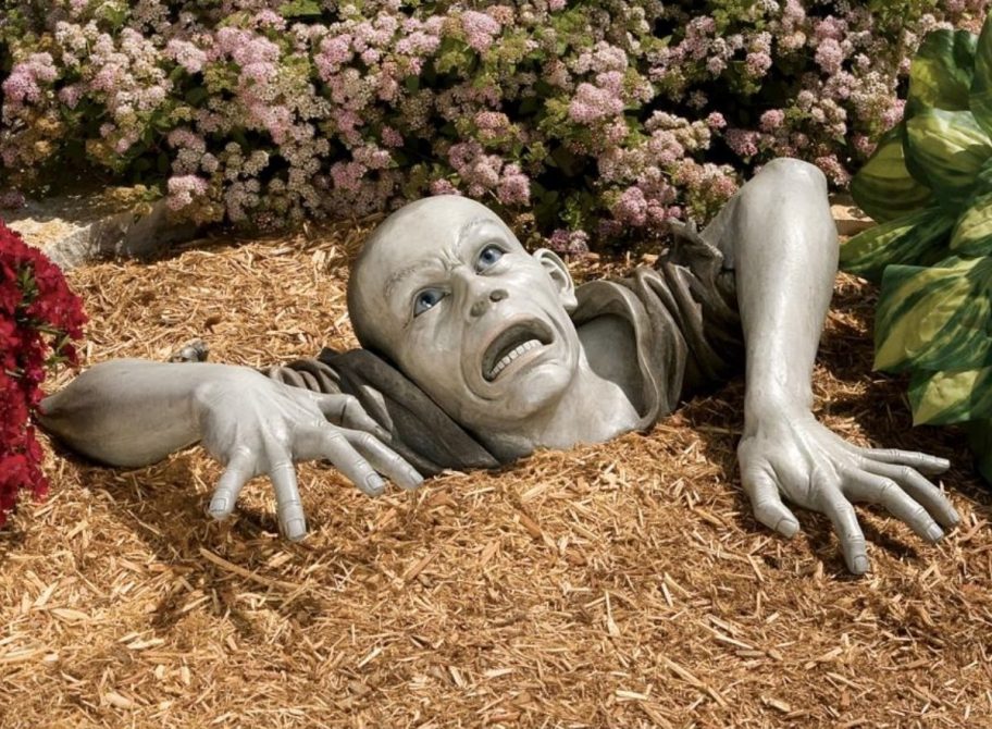 Zombie Statue onlineing out of the ground, depicting one of the strange and weird scholarships, the Zombie Apocalypse Scholarship