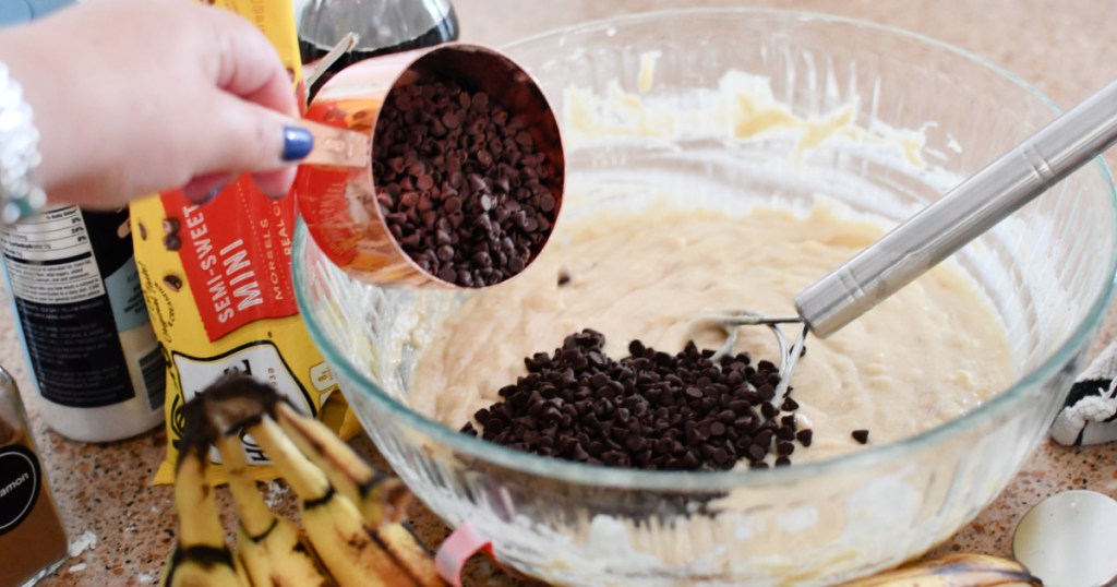 adding chocolate chips to banana bread