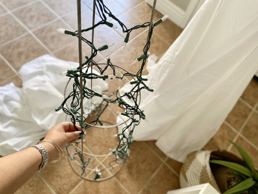 adding christmas lights to a tomato cage