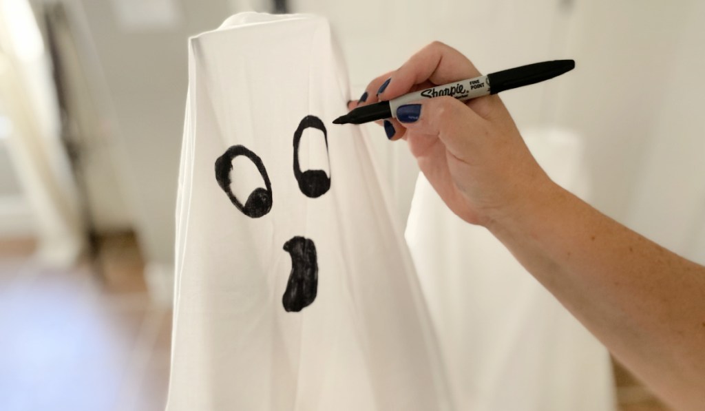 adding face with sharpie to tomato cage ghosts