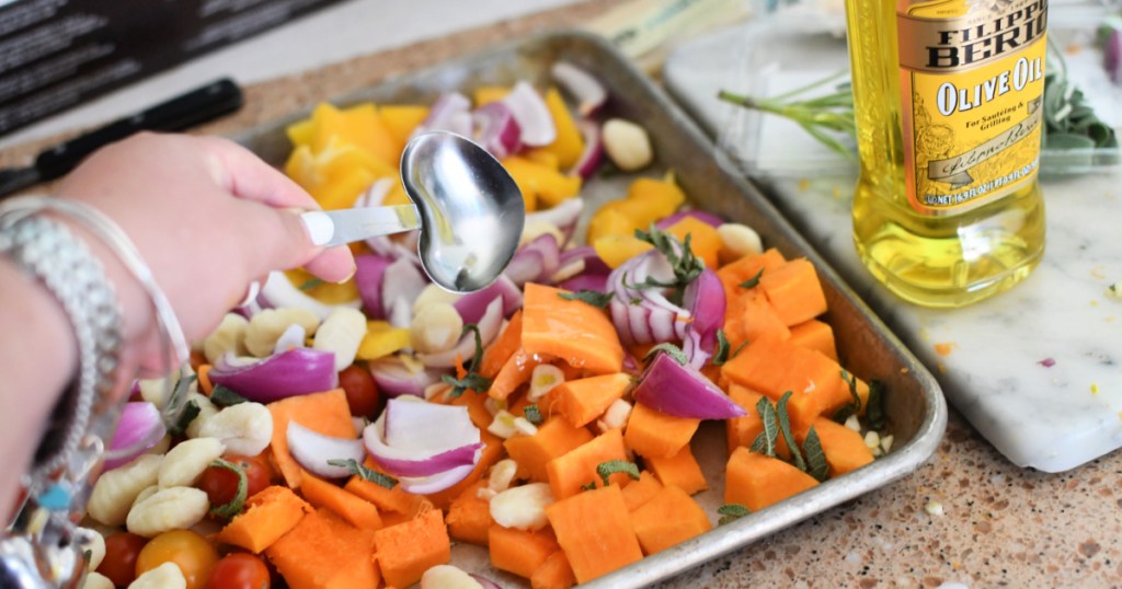 adding olive oil to sheet pan meal