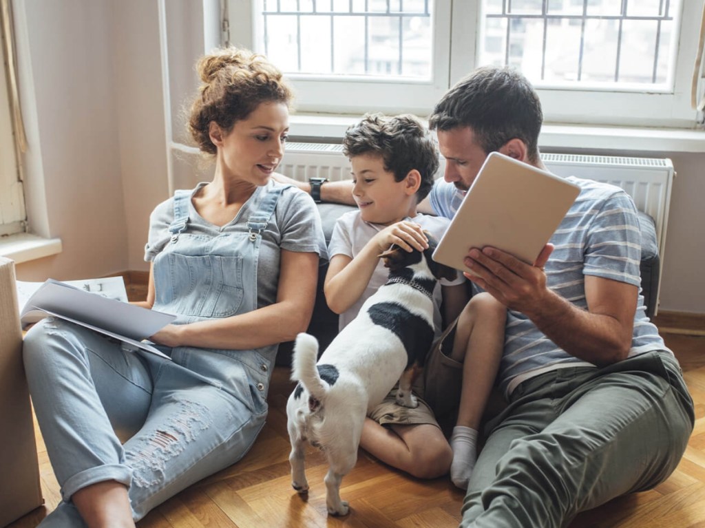 parents and child with dog