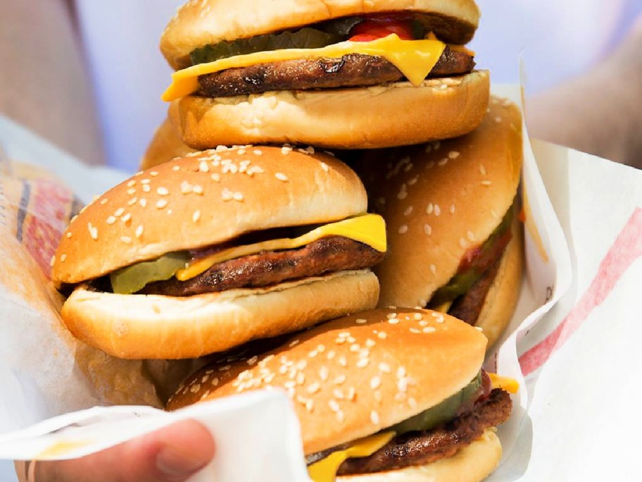 burger king cheeseburgers stacked on paper 