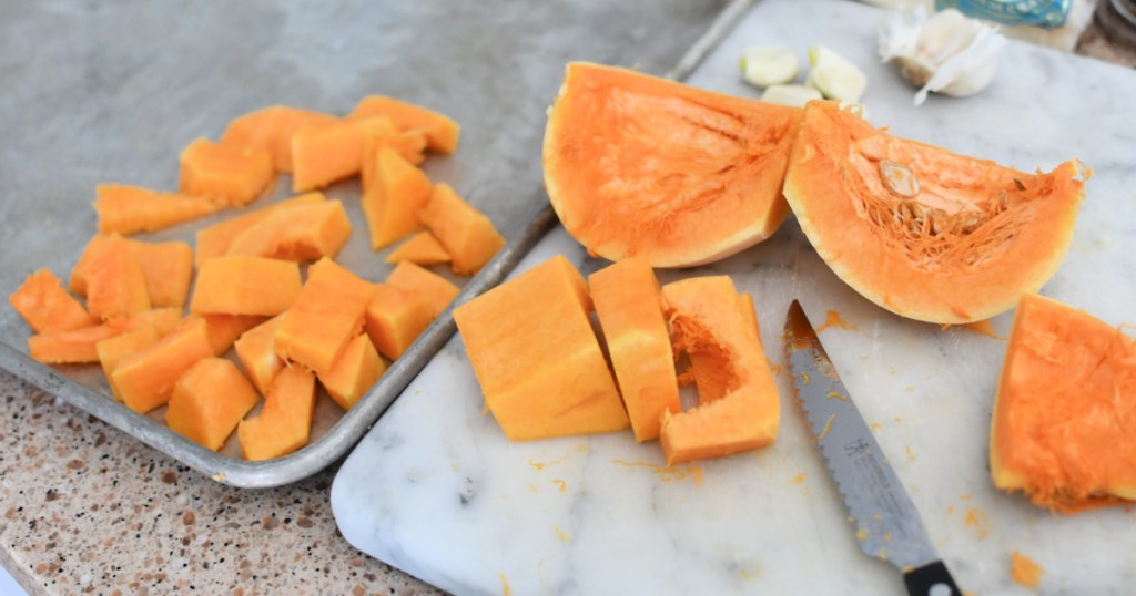 chopping butternut squash for sheet pan pasta gnocchi bake