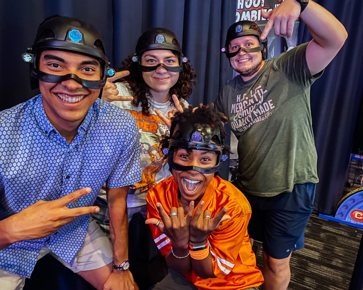 people wearing black helmets in arcade