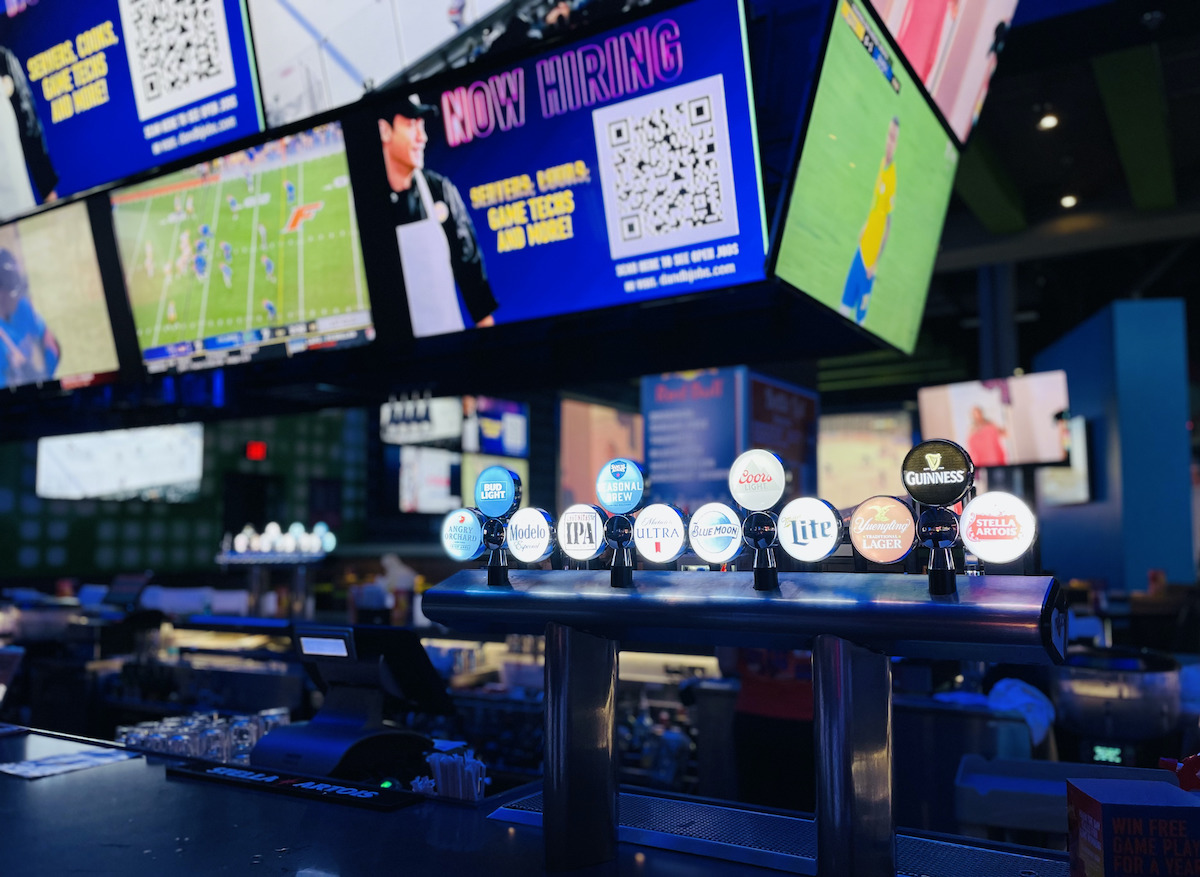 dave and busters sports bar with multiple tvs with games