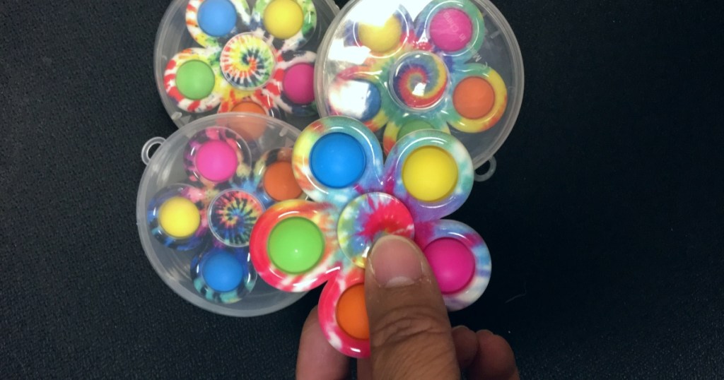 holding a pop-it fidget spinner