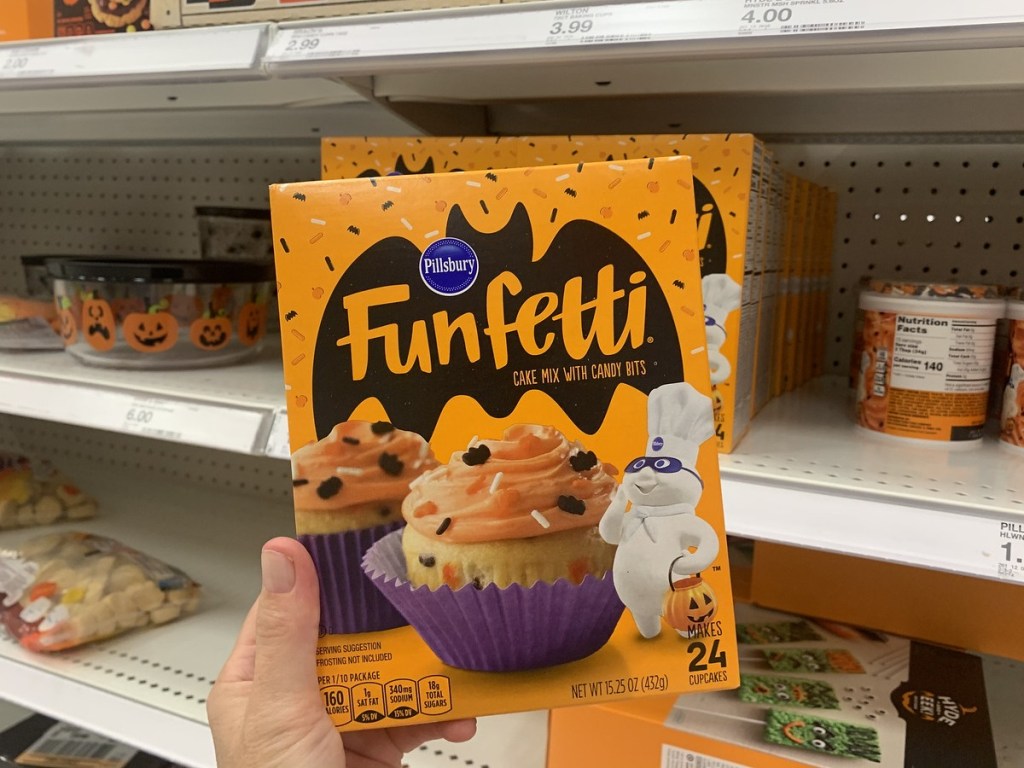 holding a box of Halloween Funfetti cake mix