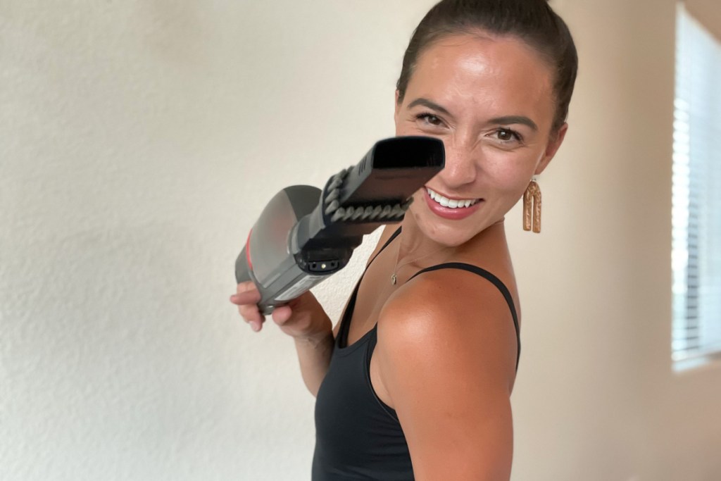 woman holding Eufy handheld vacuum