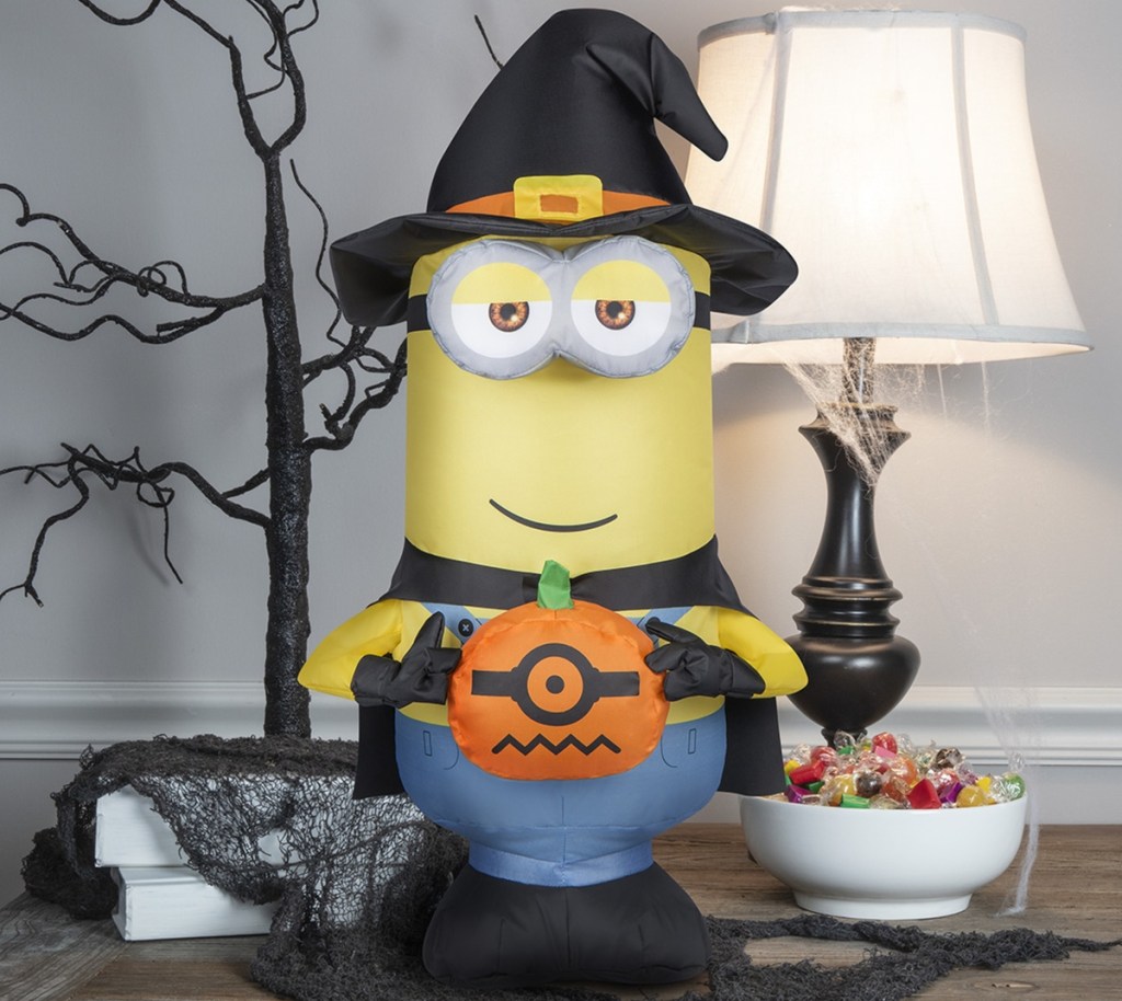 inflatable Minion holding a pumpkin