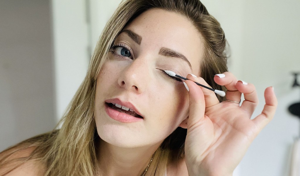 woman using reusable q tip on eyelid