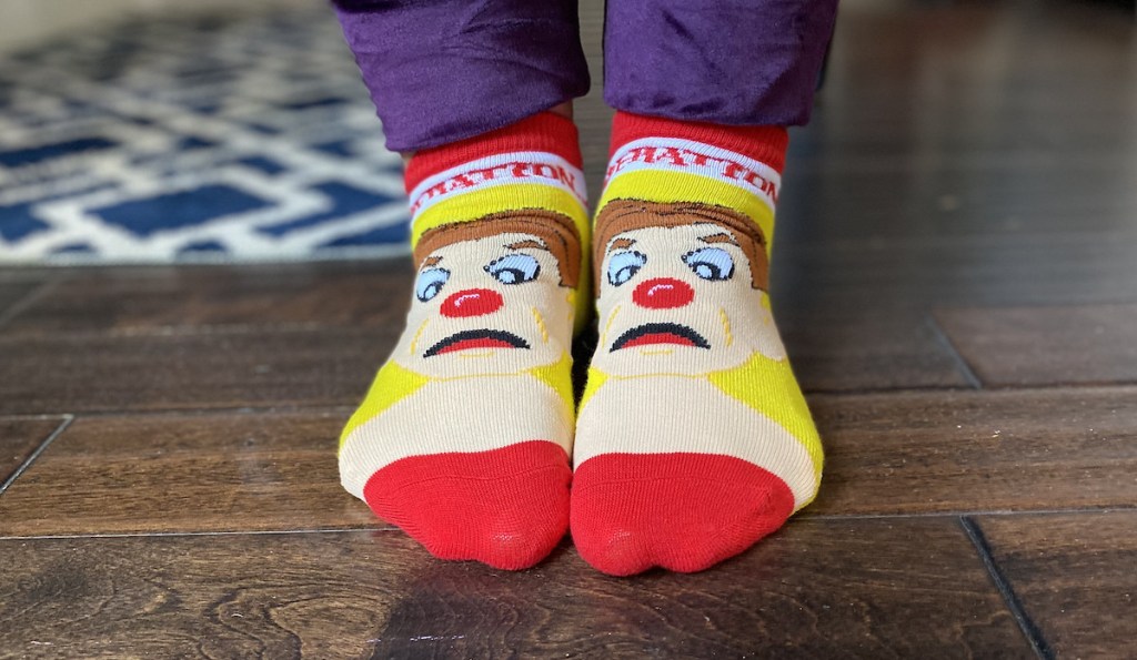 person wearing operation socks on wood floor